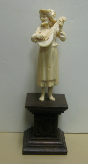 Appraisal: CONTINENTAL IVORY FIGURE OF MUSICIAN Carved as an elder man