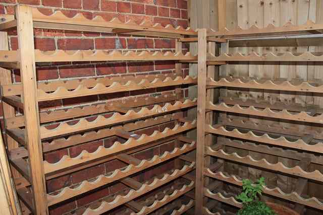 Appraisal: THREE LARGE PINE FREE STANDING WINE RACKS each capable of