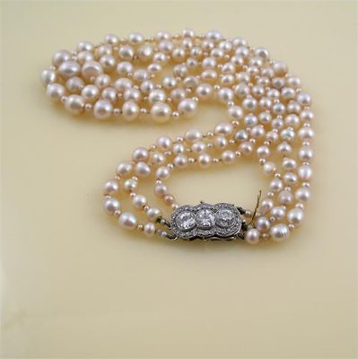 Appraisal: A three row pearl necklace the principle pearls graduate from