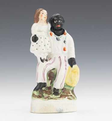 Appraisal: A Miniature Uncle Tom Eva Figural Seated Uncle Tom with