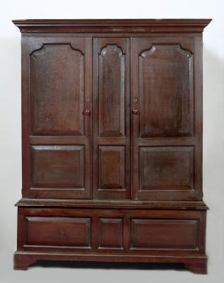 Appraisal: A GEORGE III OAK LIVERY CUPBOARD the moulded cornice over