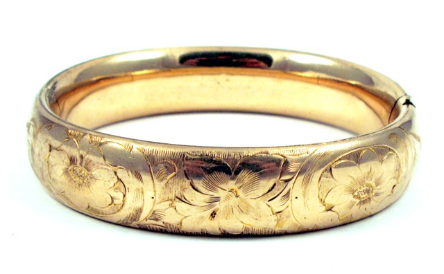 Appraisal: FOURTEEN KARAT GOLD BANGLE wide and weighing grams