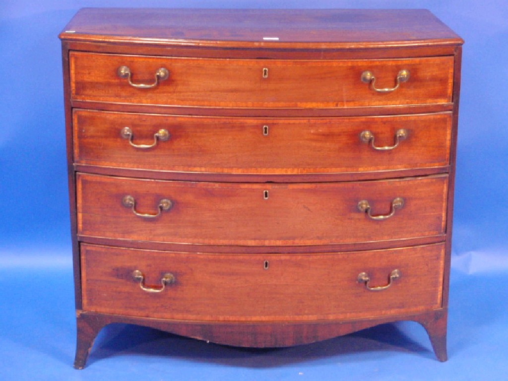 Appraisal: A George III Sheraton style bow fronted mahogany chest of