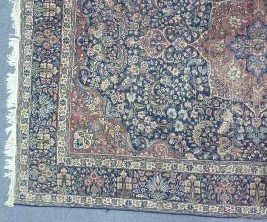 Appraisal: An Oriental rug with madder medallion and spandrels on an