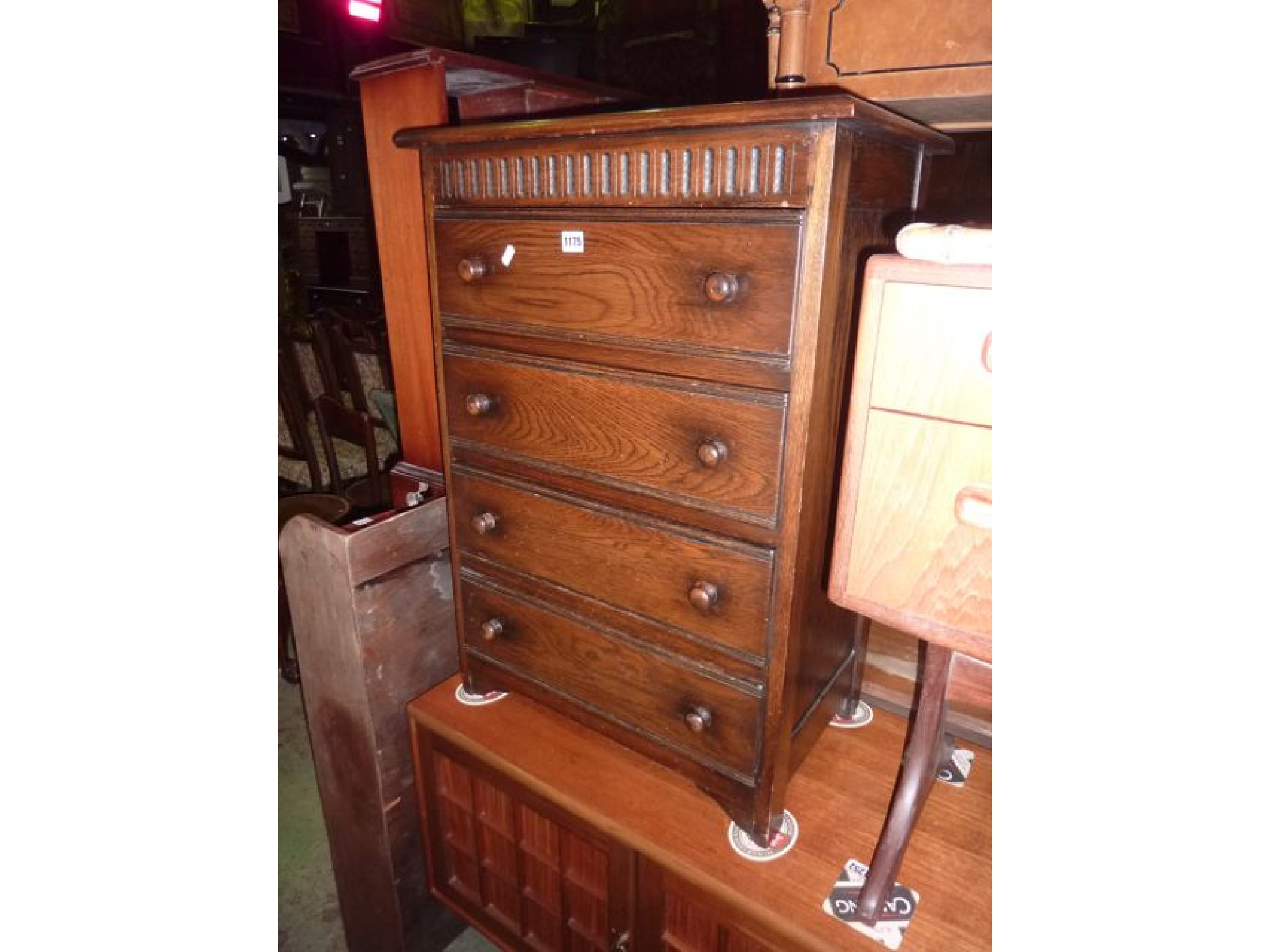 Appraisal: A small reproduction oak chest of four long inverted graduated