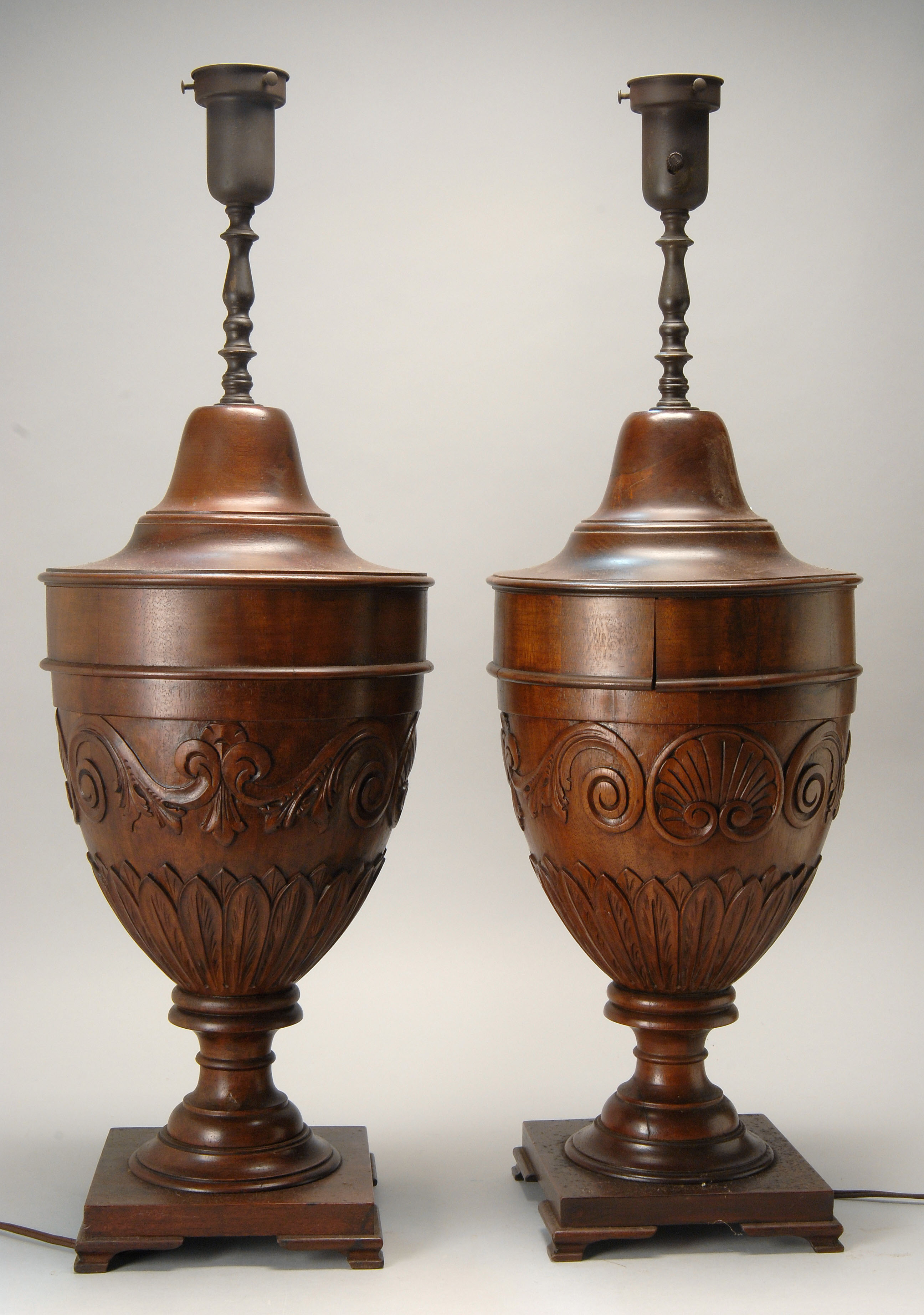 Appraisal: PAIR OF DECORATIVE CARVED WOOD LAMPS in urn form Heights