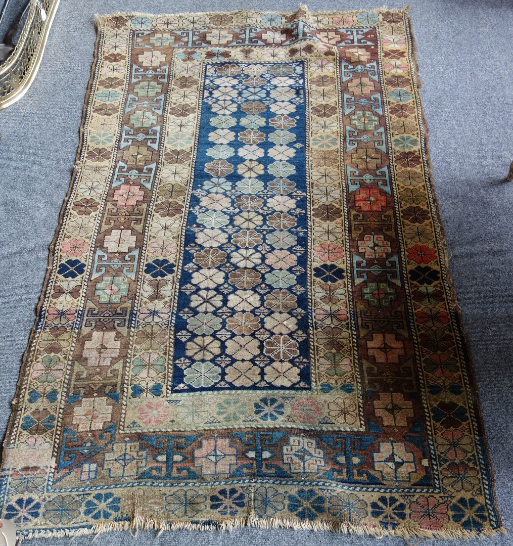 Appraisal: A Caucasian rug the indigo field filled with single flowerheads