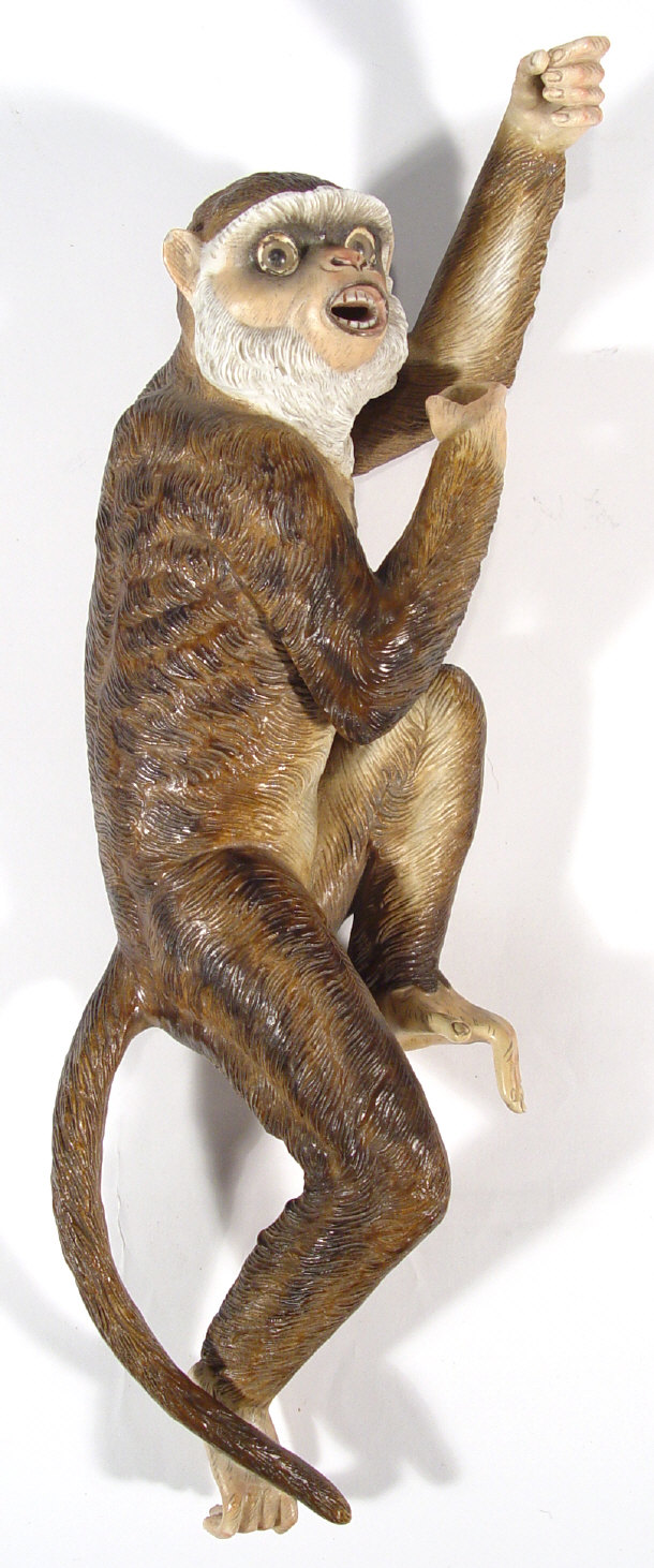 Appraisal: Continental porcelain monkey in climbing pose with glass eyes and