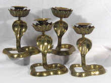 Appraisal: A set of four brass candlesticks each in the form