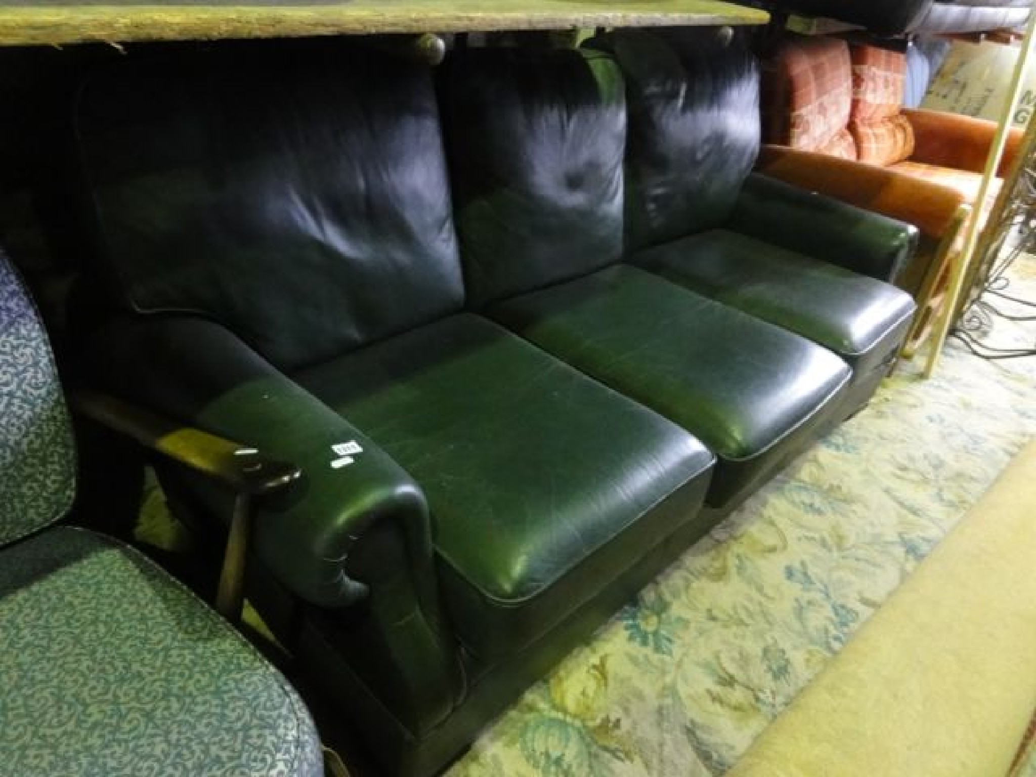 Appraisal: A contemporary three seat green leather sofa with rolled arms