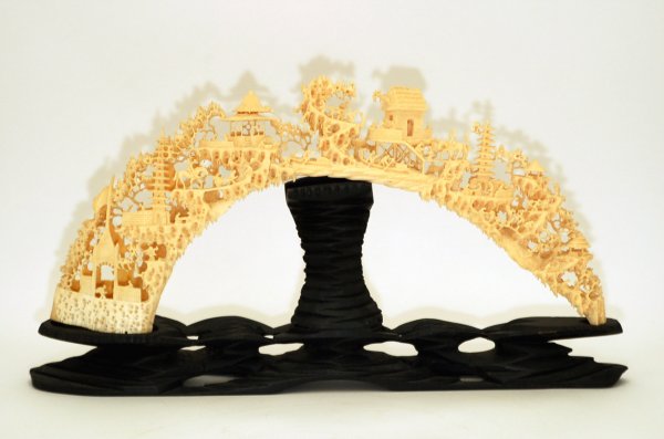 Appraisal: Elephant tusk intricately carved into bridge with buildings figures and