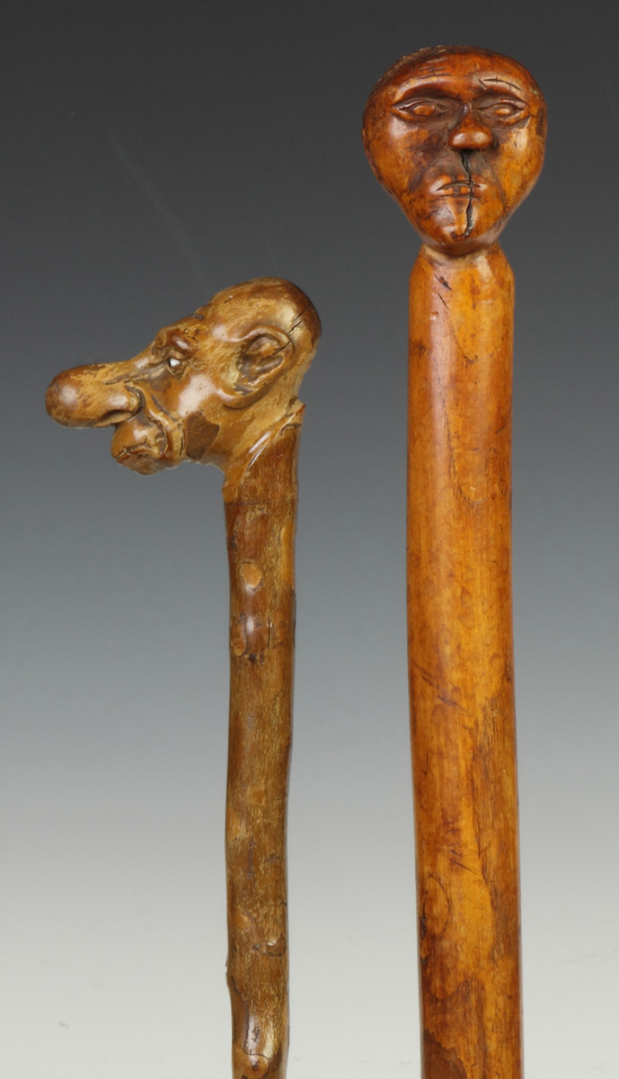 Appraisal: Two Folk Art Canes w Carved Heads th cent One