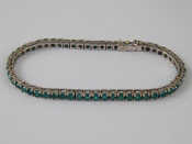 Appraisal: A white metal tests carat gold emerald line bracelet the