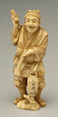 Appraisal: Japanese ivory okimono carving of man holding two sticks attached