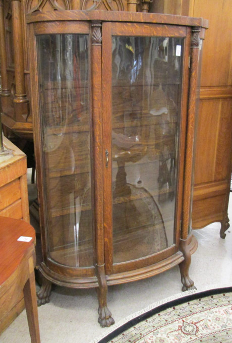 Appraisal: AN OAK AND CURVED GLASS CHINA CABINET American late th