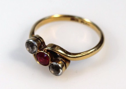 Appraisal: A ladies cross over ring centred with a red stone