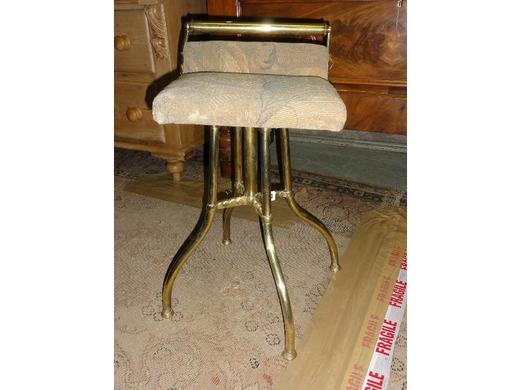 Appraisal: A late Victorian brass framed music stool with upholstered revolving