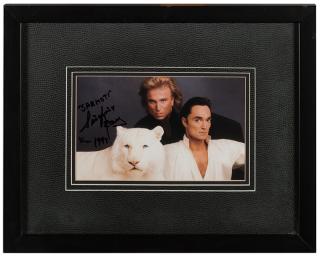 Appraisal: Siegfried Roy Signed Color Photograph The duo depicted with a