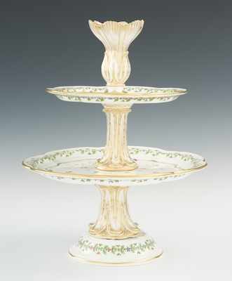 Appraisal: A Two-Tiered Porcelain Cake Server The pretty cake server is