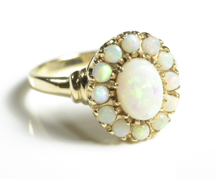 Appraisal: OPAL AND TEN KARAT YELLOW GOLD RING with twelve round