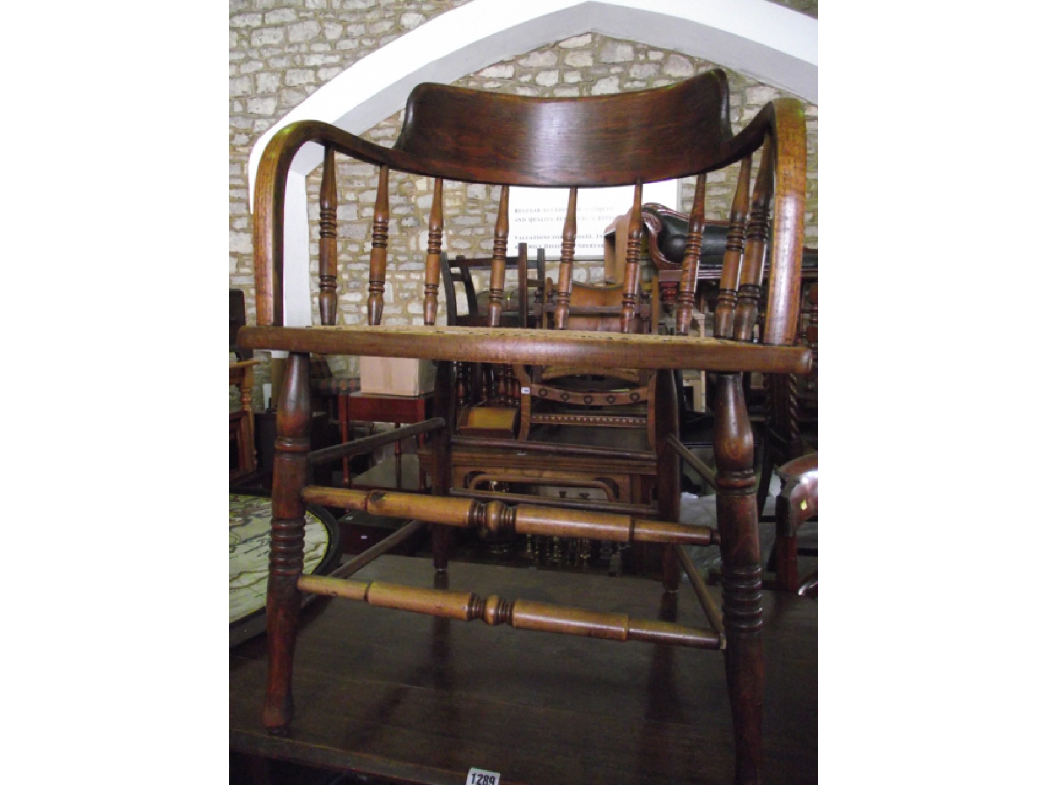 Appraisal: An ashwood hoop back office chair with cane panelled seat