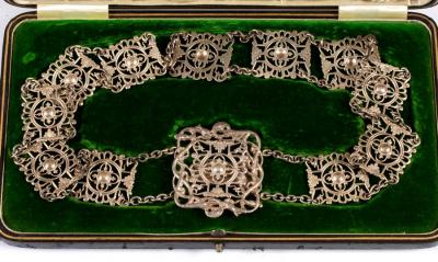 Appraisal: An Edwardian silver belt Walker Hall Sheffield of pierced rectangular