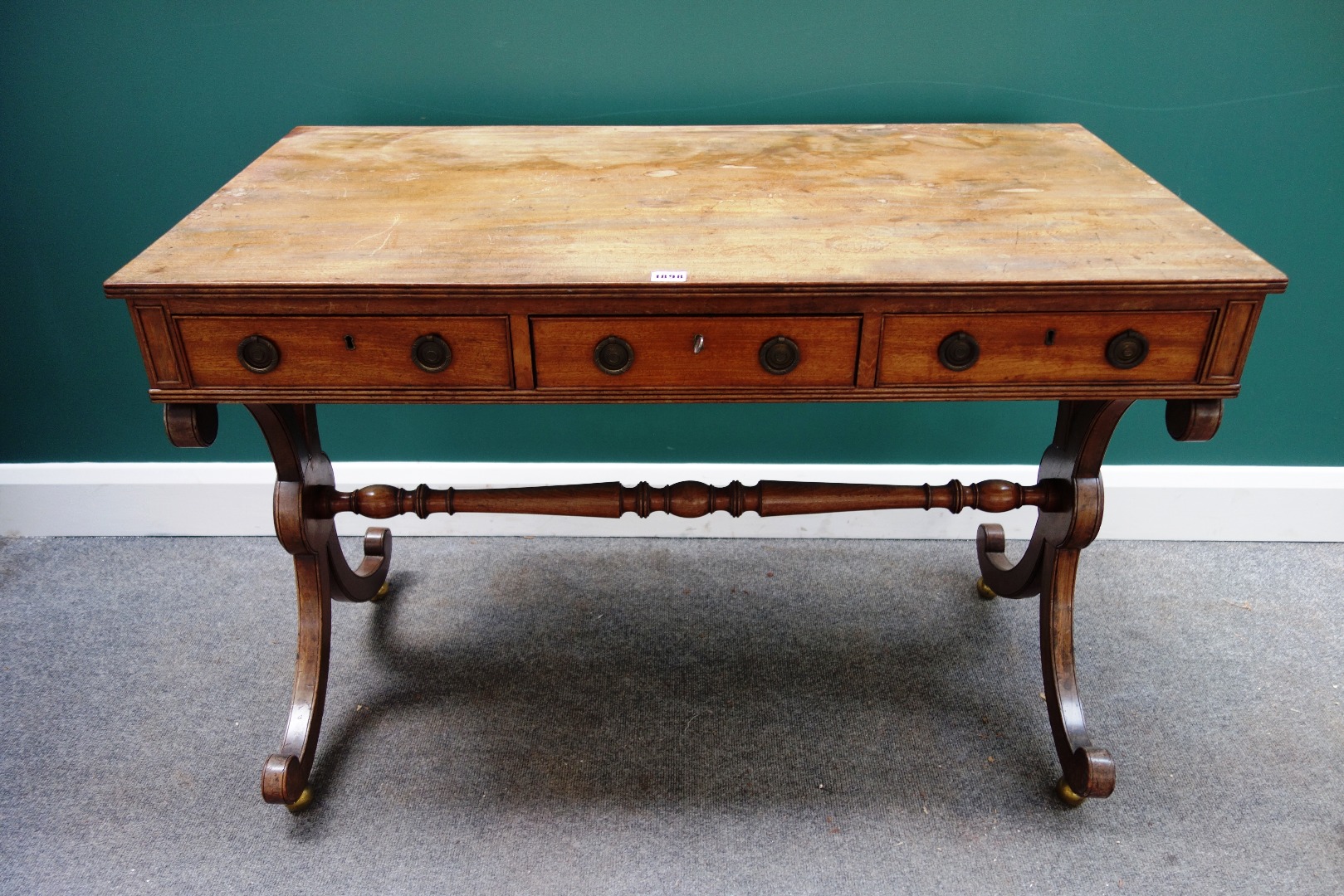 Appraisal: A Regency mahogany sofa table with three frieze drawers and