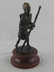 Appraisal: A cast bronze figure of an African with staff Ht