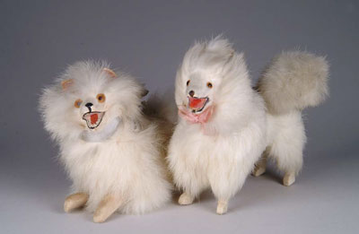 Appraisal: PAIR OF SPITZ DOGS CANDY CONTAINERS One lying one standing