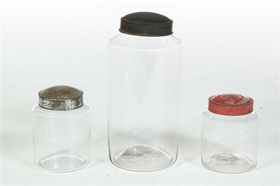 Appraisal: THREE BLOWN GLASS CANISTERS American th century With tin lids