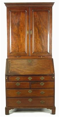 Appraisal: A mahogany bureau cabinet the dentil moulded cornice above a