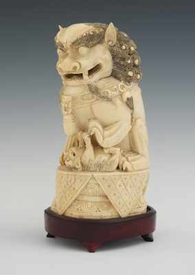 Appraisal: A Large Chinese Carved Ivory Foo Lion on Rosewood Stand