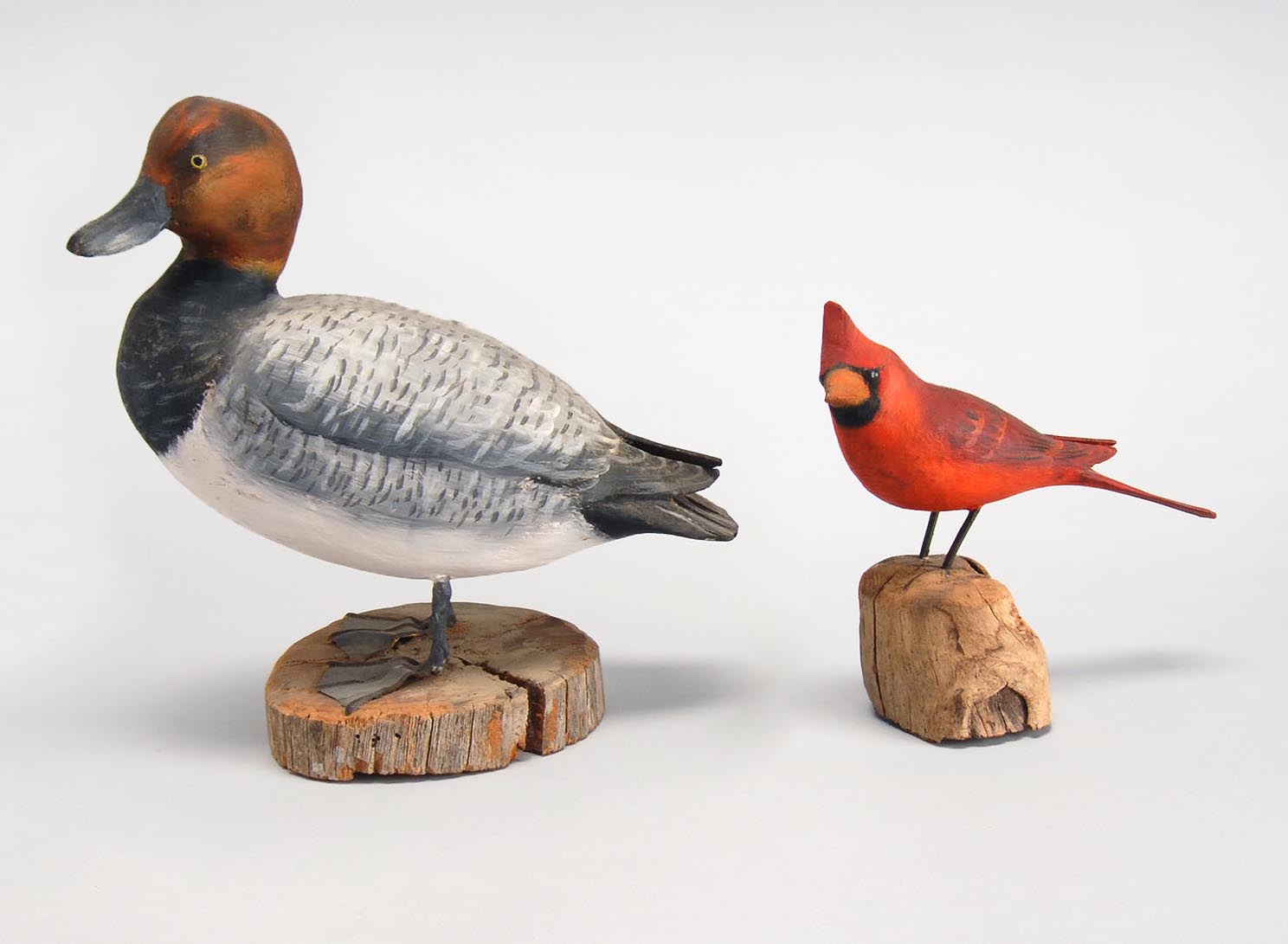 Appraisal: TWO BIRD CARVINGS A near life-size cardinal and a quarter-size