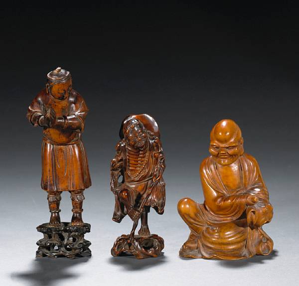 Appraisal: A group of three carved wood figures The first a