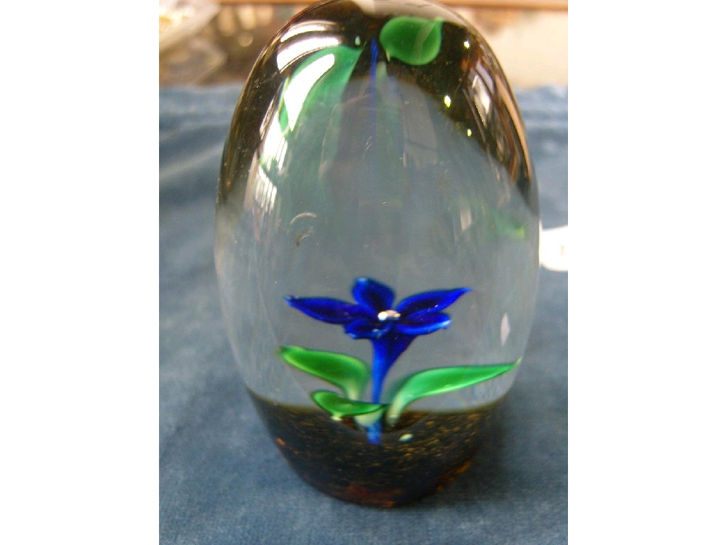 Appraisal: A paperweight of tall domed form enclosing a blue flower