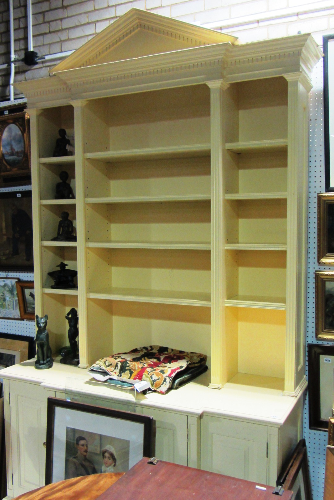 Appraisal: A large th century yellow painted breakfront bookcase