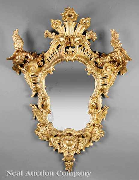 Appraisal: An Antique Louis XVI-Style Carved Giltwood Mirror flared pierced crest