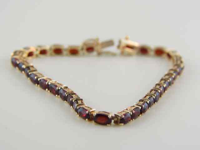 Appraisal: Garnet Tennis Bracelet oval gems totaling carats in k yellow