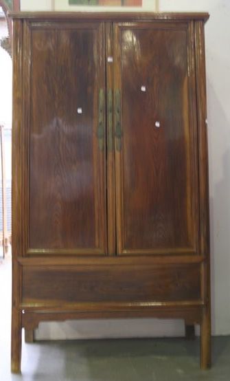 Appraisal: A Ming tapered two door cabinet of elm wood with