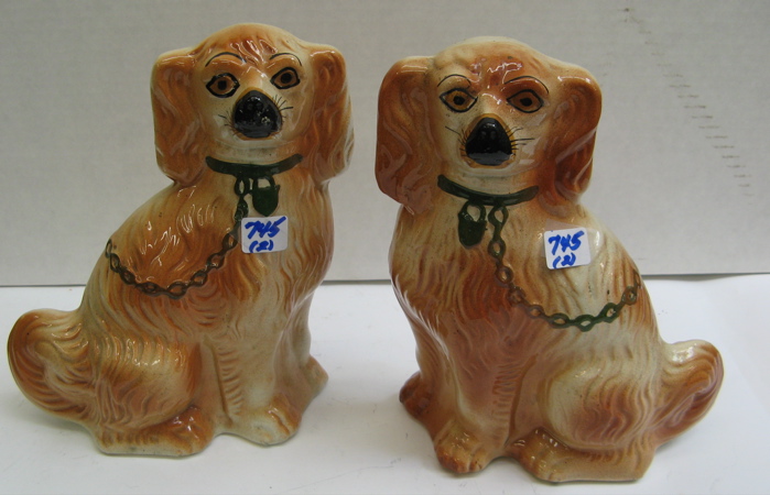 Appraisal: PAIR ENGLISH STAFFORDSHIRE POTTERY SPANIELS Tan and off-white with green