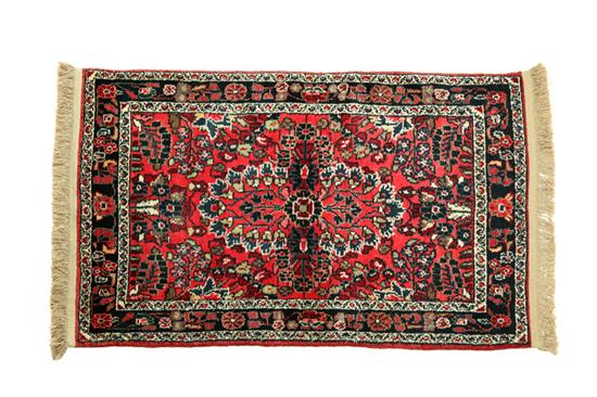 Appraisal: ORIENTAL RUG Dergazine Floral design on red ground Added fringe