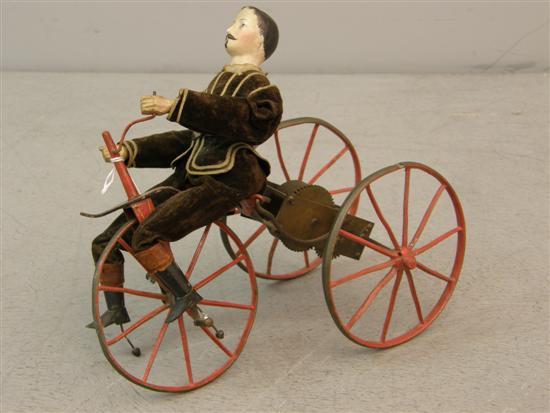 Appraisal: Early th century clockwork tricycle toy with bisque figure h