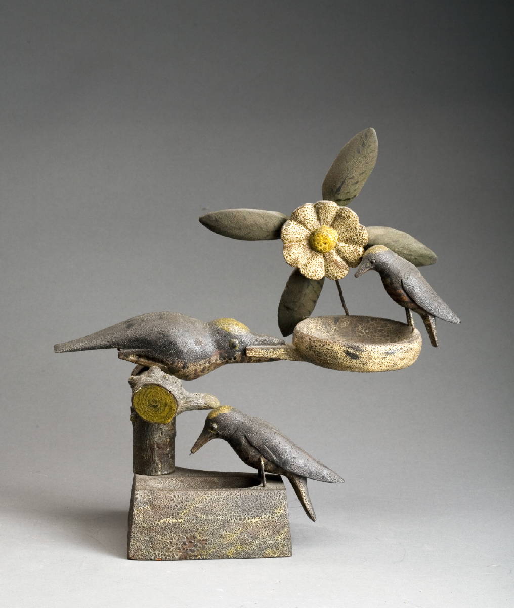 Appraisal: CARVED AND PAINTED GROUPING OF THREE SONG BIRDS A FLOWER