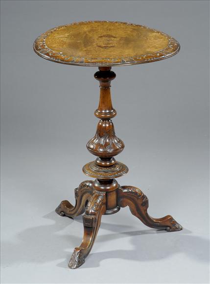 Appraisal: A Victorian walnut circular tripod occasional table in rococo revival