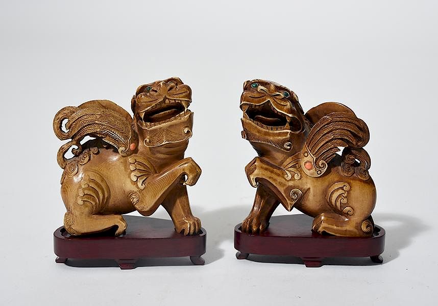 Appraisal: Pair of Chinese carved jeweled ivory foo lions Pair of