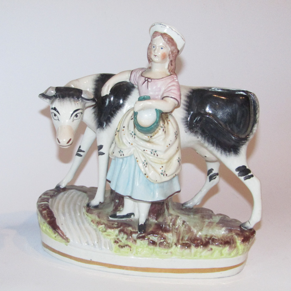 Appraisal: A thC Staffordshire milkmaid group formed as a cow and