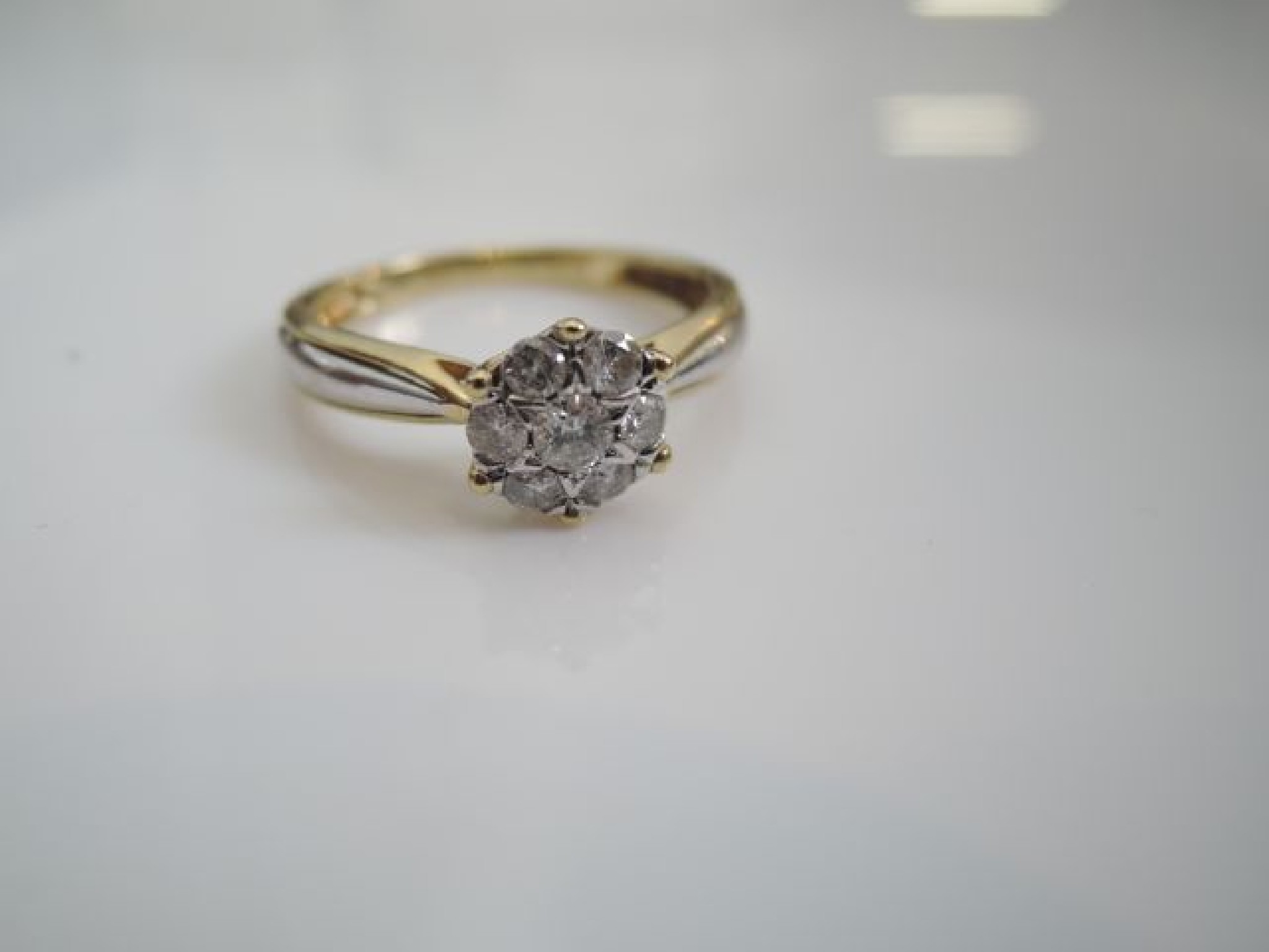 Appraisal: A diamond flower head ring set with seven round brilliant-cut