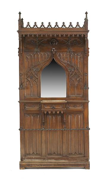 Appraisal: A French Gothic style walnut hall stand The crest with