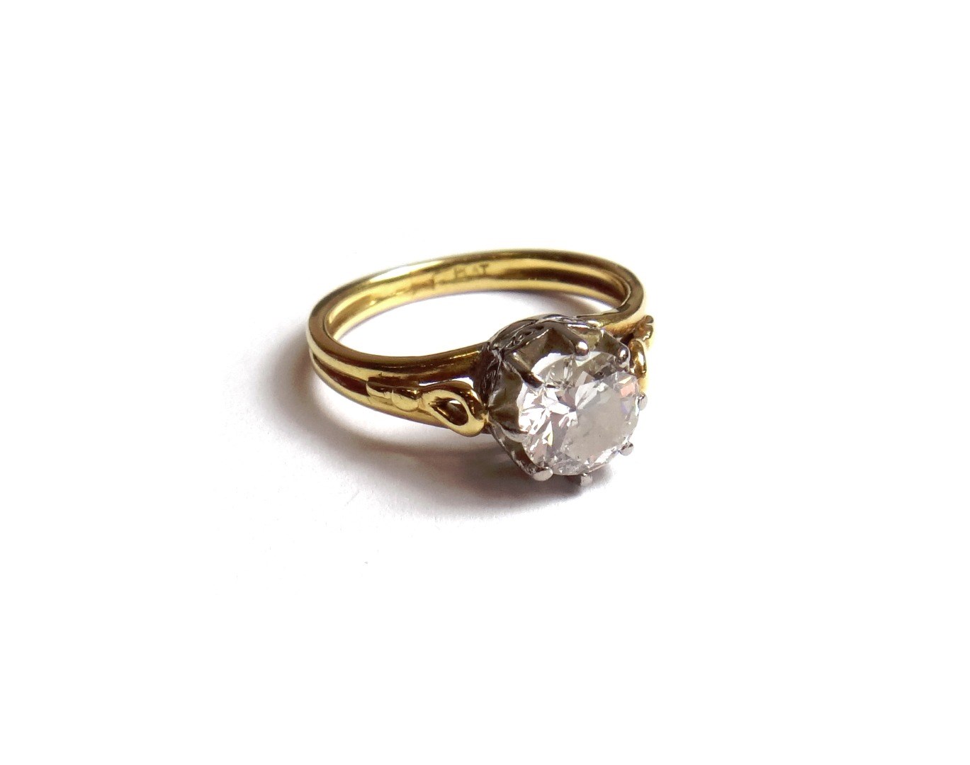 Appraisal: A gold and platinum diamond set single stone ring claw