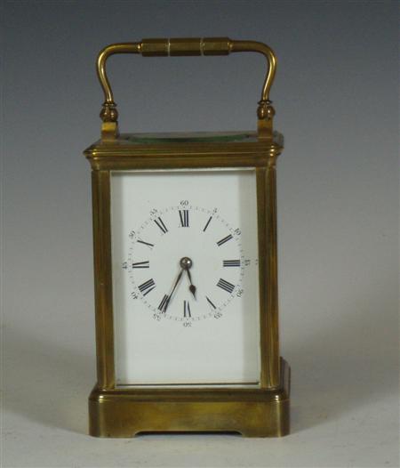 Appraisal: A brass cased carriage clock with white dial and black